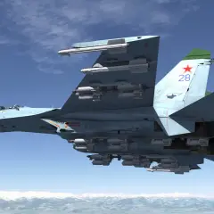 Suchoi Su-27 mit vielen Raketen, fliegt über schneebedeckte Berge.