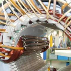 Detailaufnahme vom Wickeln eines Elektromotors mit Kupferdraht und Isoliermaterial.