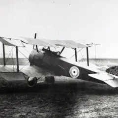 Ein Sopwith Pup Doppeldeckerflugzeug mit der Kennung A 7302 steht auf einem Feld.