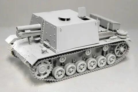 Graues Modell eines Geschützpanzers, das an die sig 33 erinnert, mit detaillierten Ketten und einer großen Kanone.