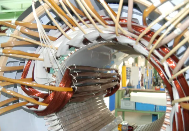 Detailaufnahme vom Wickeln eines Elektromotors mit Kupferdraht und Isoliermaterial.