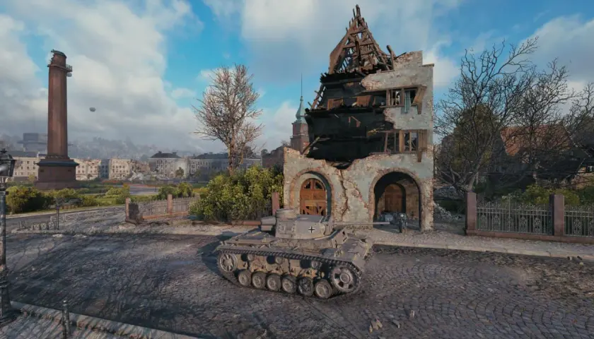 Ein Panzer III J steht vor einer zerstörten Ruine in einer Stadt.