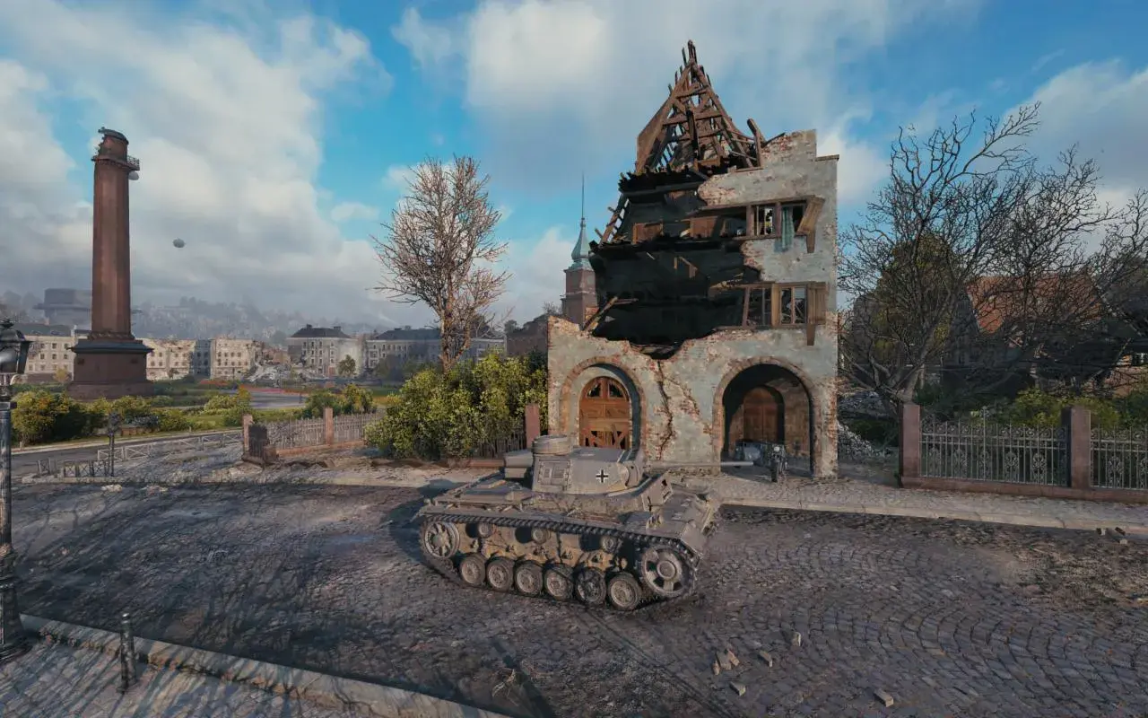 Ein Panzer III J steht vor einer zerstörten Ruine in einer Stadt.